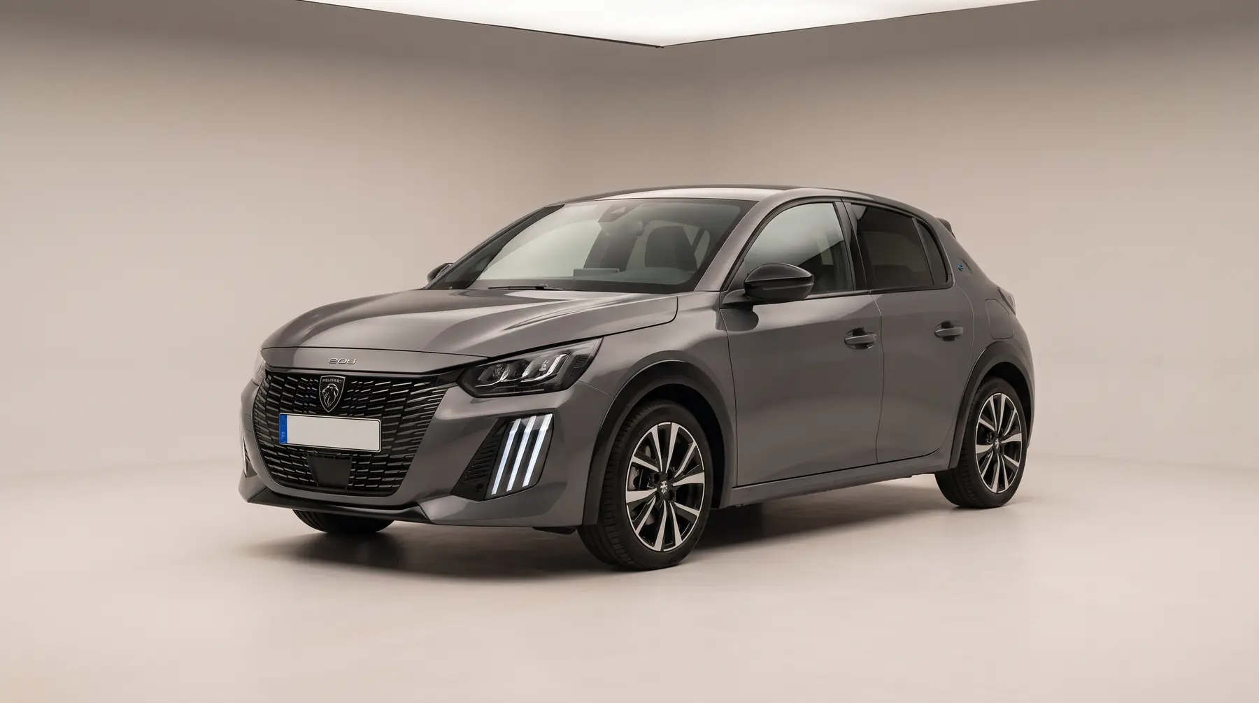 A dark grey hatchback in a studio