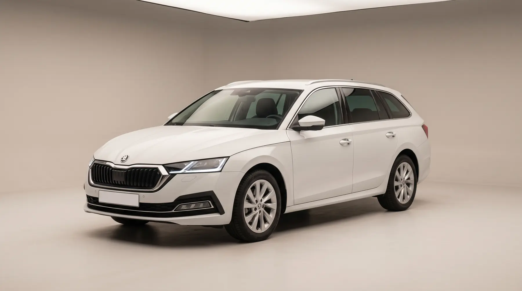 A white estate car in a studio