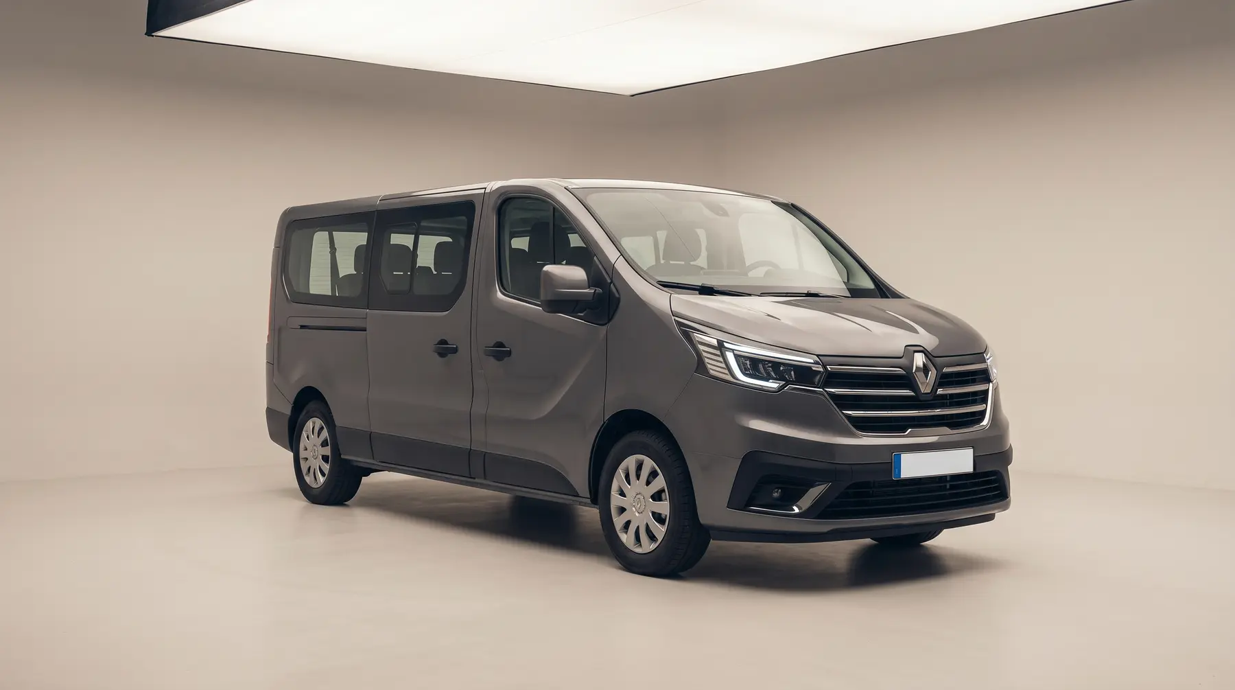 A grey minibus in a studio